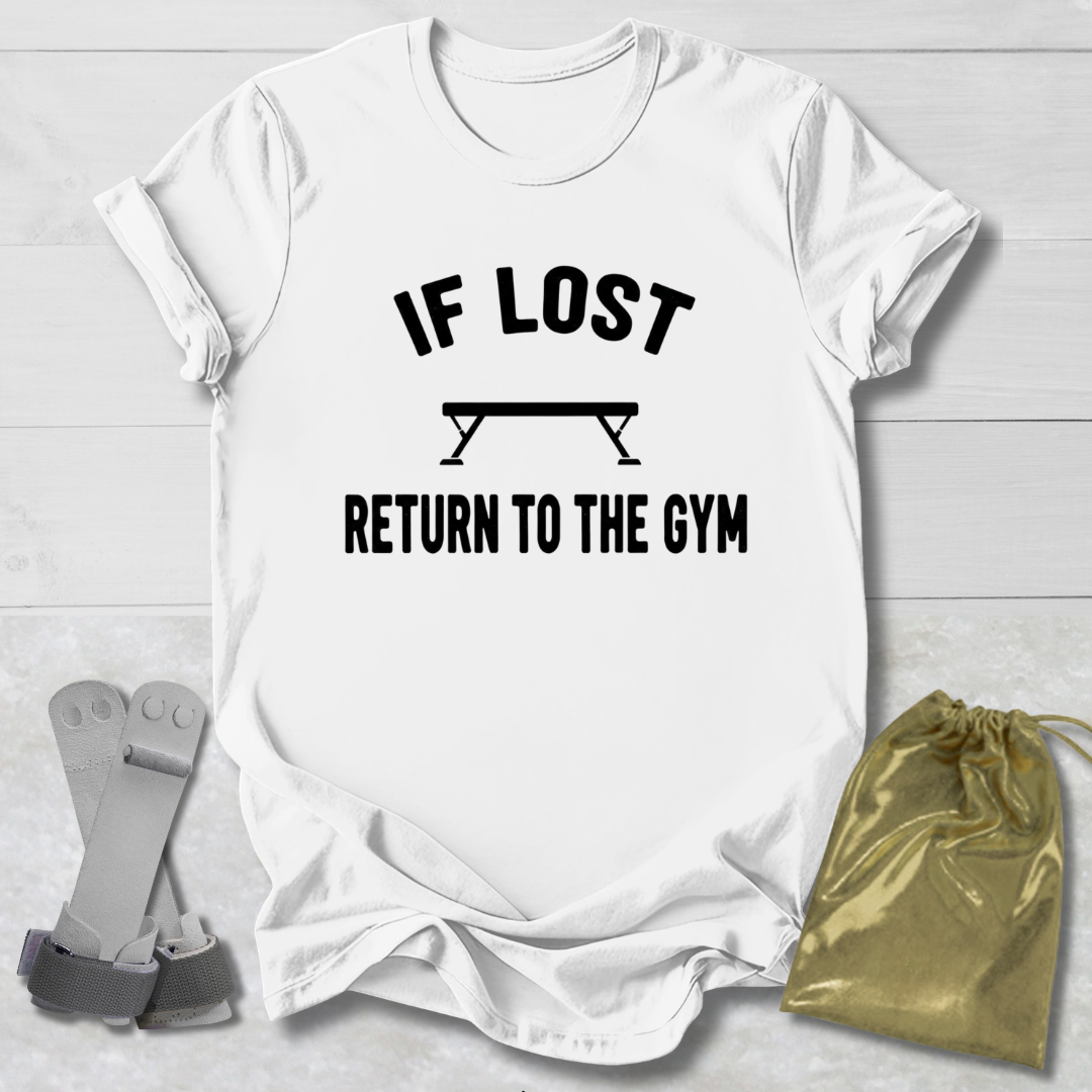 White t-shirt with 'If lost, return to the gym' text on a light wooden surface with socks and a drawstring bag.