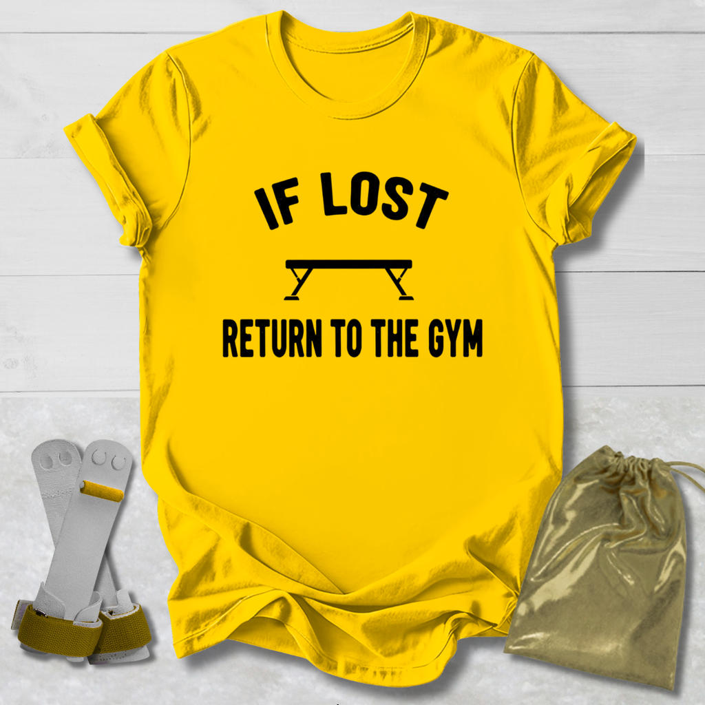 Yellow t-shirt with 'If lost, return to the gym' text on a light wooden surface.