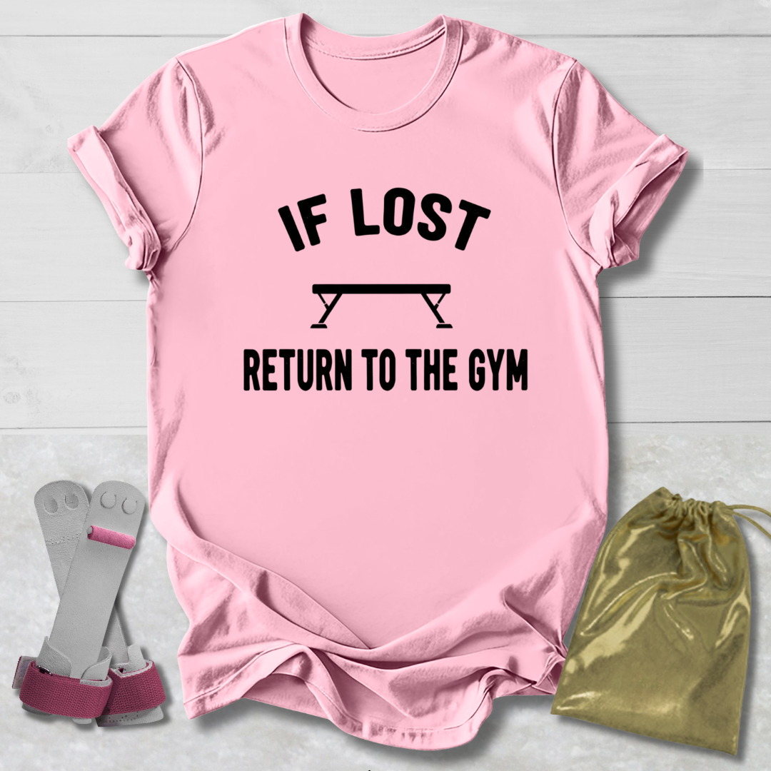 Pink t-shirt with 'If lost, return to the gym' text on a light wooden surface with socks and a drawstring bag.