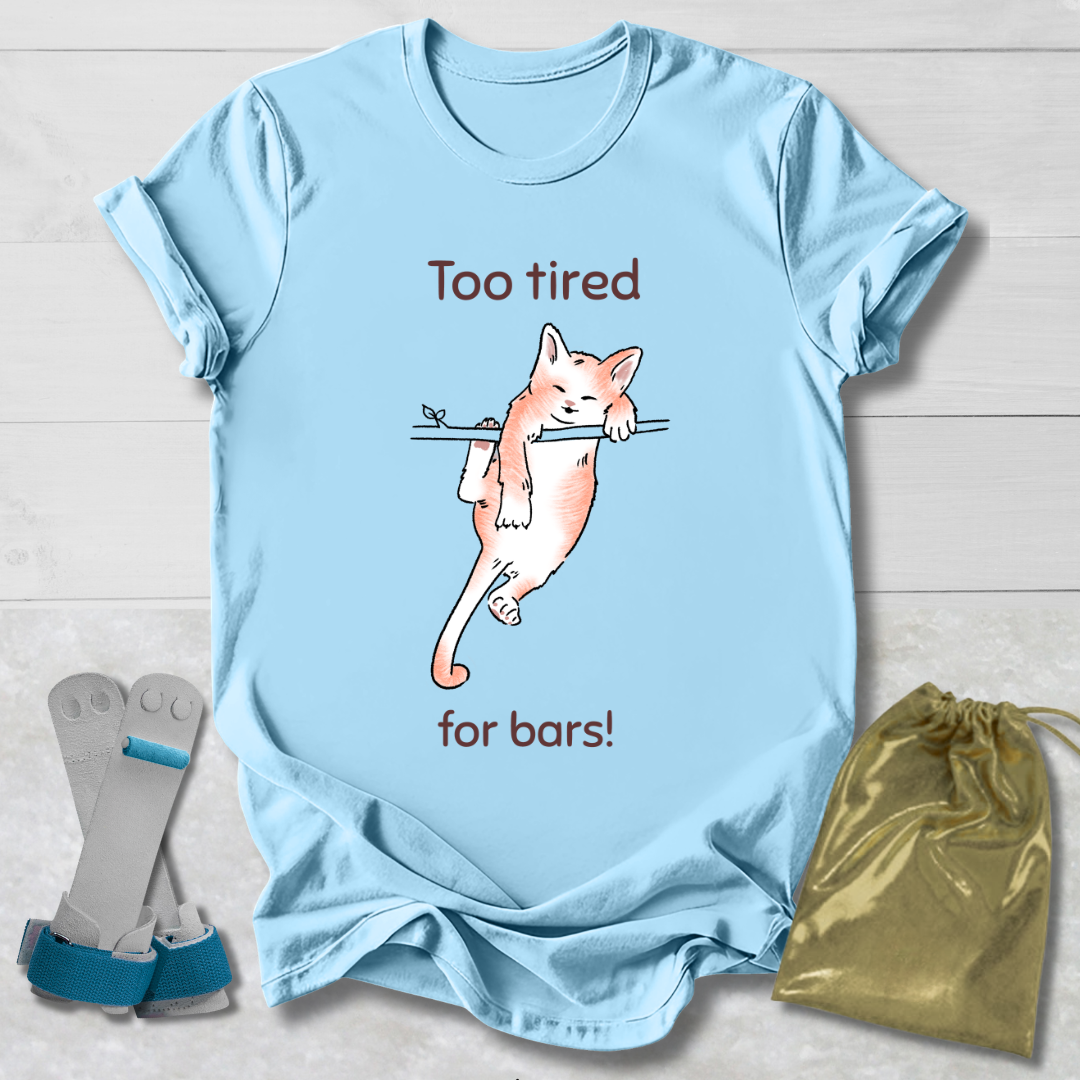 Light blue t-shirt with a cat graphic and text, socks, and a drawstring bag on a wooden surface.