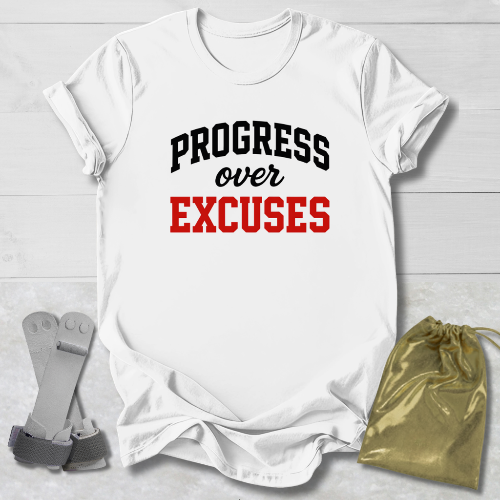 White t-shirt with 'PROGRESS over EXCUSES' text on a light wooden surface with socks and a drawstring bag.