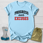Light blue t-shirt with 'PROGRESS over EXCUSES' text, socks, and drawstring bag on a light wooden surface.