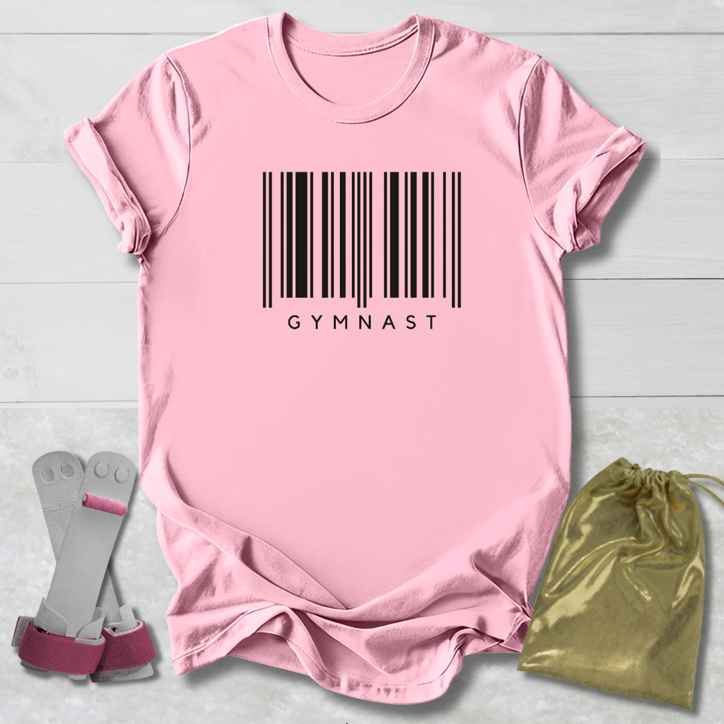 Pink t-shirt with barcode and 'GYMNAST' text, socks, and drawstring bag on a light wooden surface