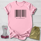 Pink t-shirt with barcode and 'GYMNAST' text, socks, and drawstring bag on a light wooden surface