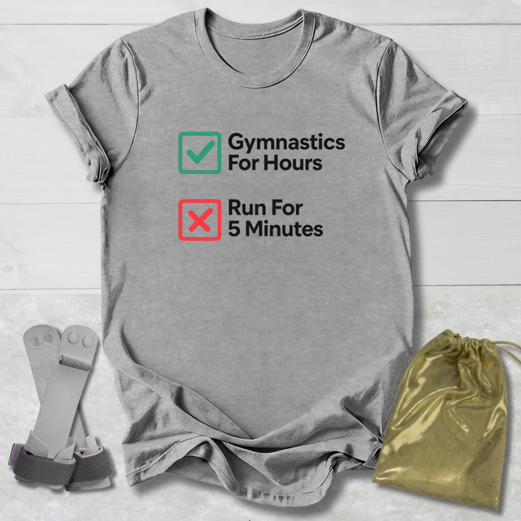 Gray t-shirt with 'Gymnastics For Hours' and 'Run For 5 Minutes' text, socks, and drawstring bag on a light wooden surface.