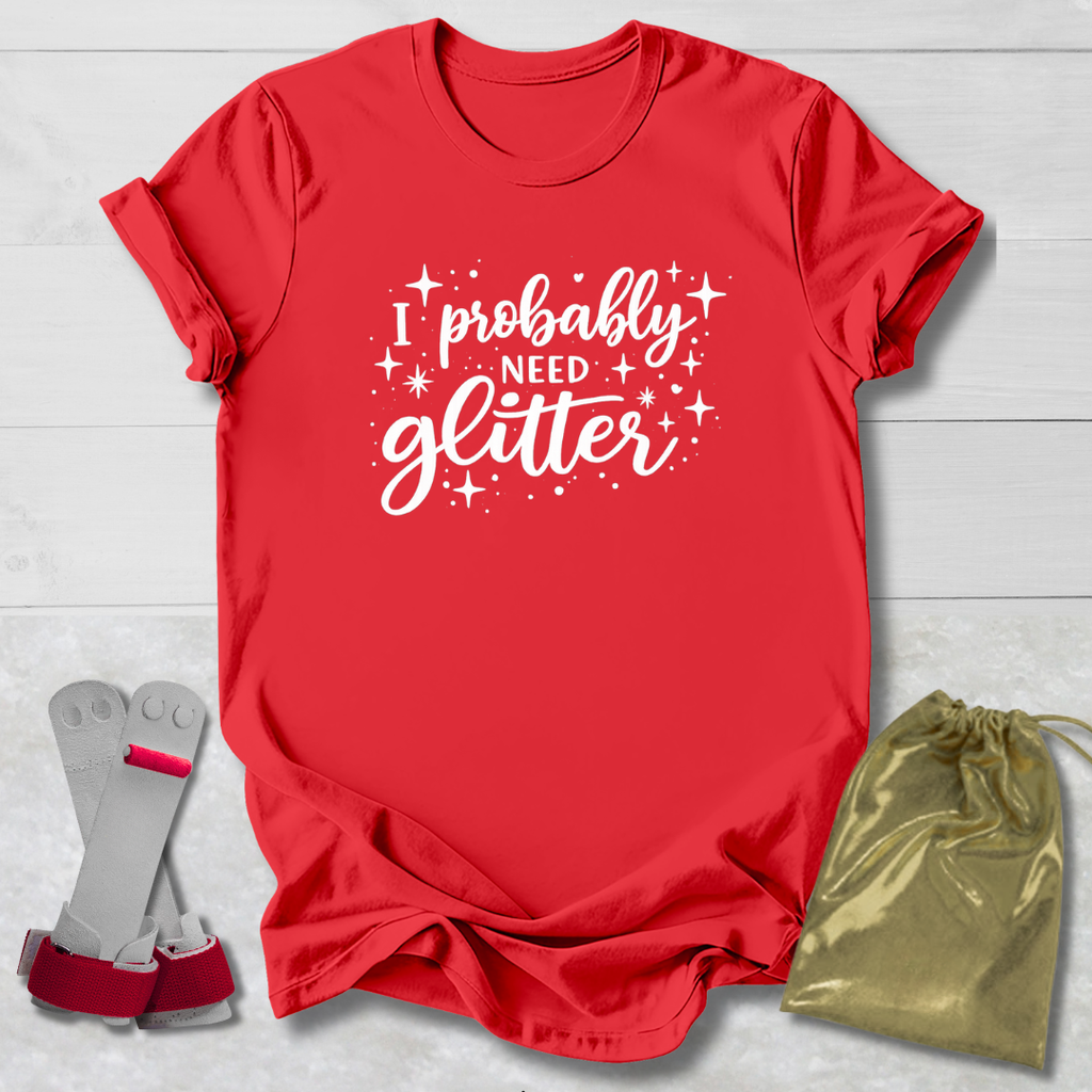 Red t-shirt with 'I probably need glitter' text, socks, and drawstring bag on a light wooden surface.