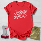 Red t-shirt with 'I probably need glitter' text, socks, and drawstring bag on a light wooden surface.