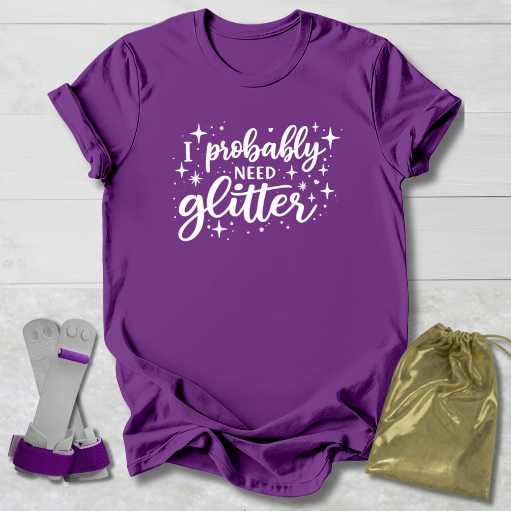 Purple t-shirt with 'I probably need glitter' text, socks, and a drawstring bag on a light wooden surface.
