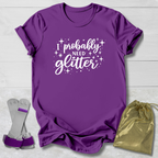 Purple t-shirt with 'I probably need glitter' text, socks, and a drawstring bag on a light wooden surface.