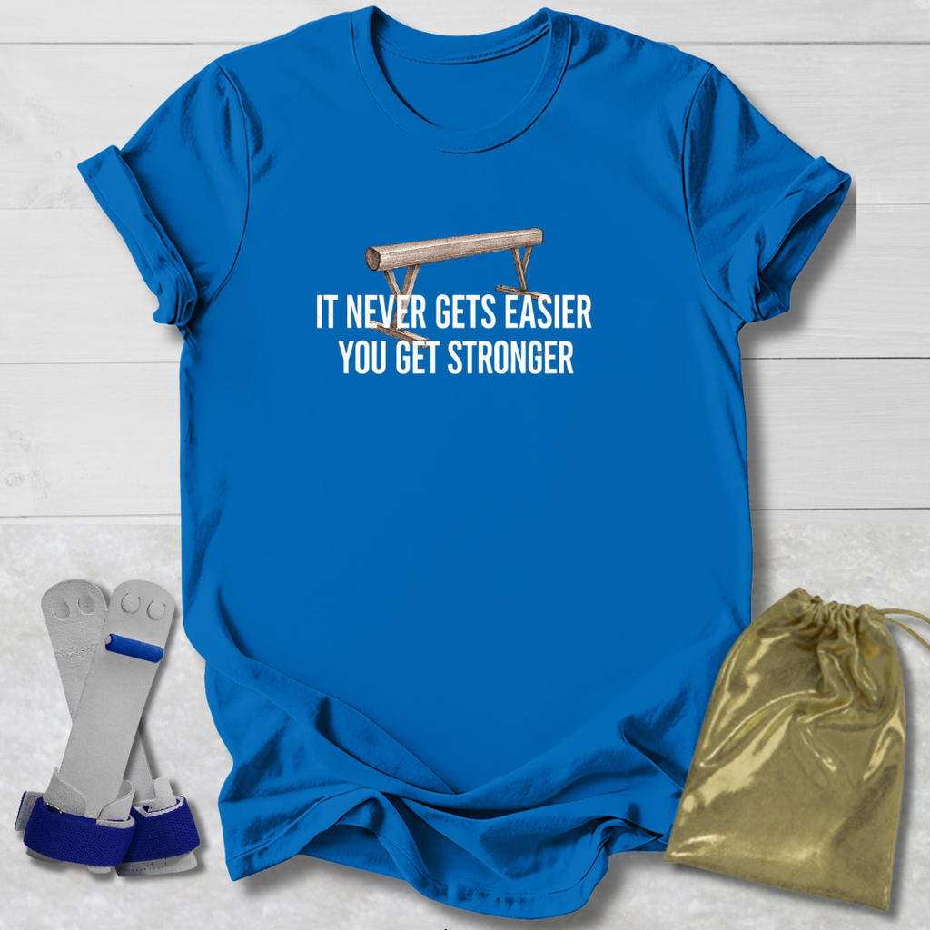 Blue t-shirt with motivational gymnastics  quote, socks, and drawstring bag on a wooden surface