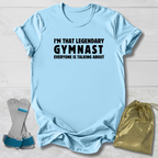 Light blue t-shirt with text, socks, and drawstring bag on a light wooden surface