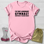 Pink t-shirt with text, socks, and drawstring bag on a light wooden surface