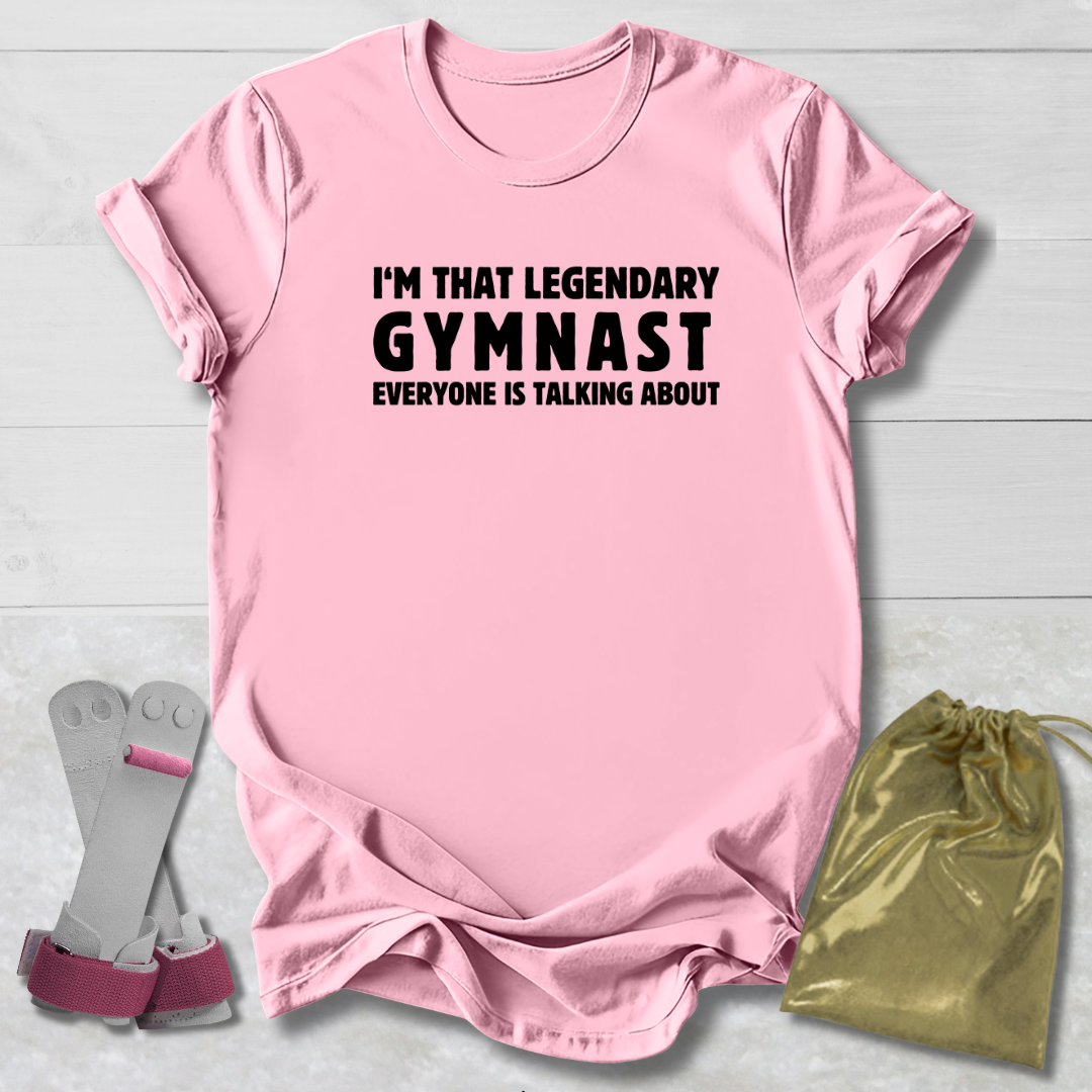 Pink t-shirt with text, socks, and drawstring bag on a light wooden surface