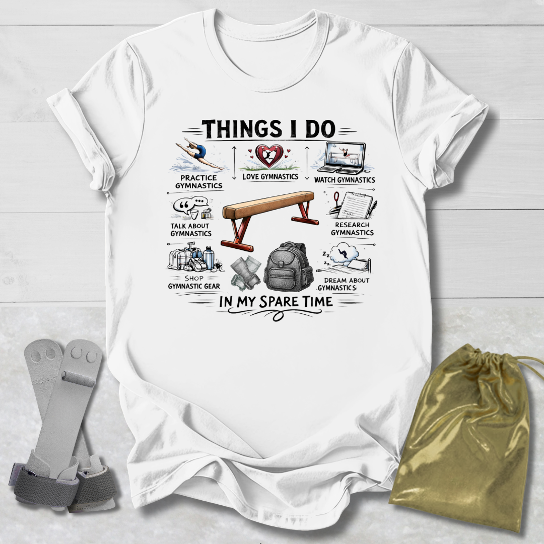 White t-shirt with a gymnastics things I do graphic design on a wooden surface with socks and a drawstring bag.