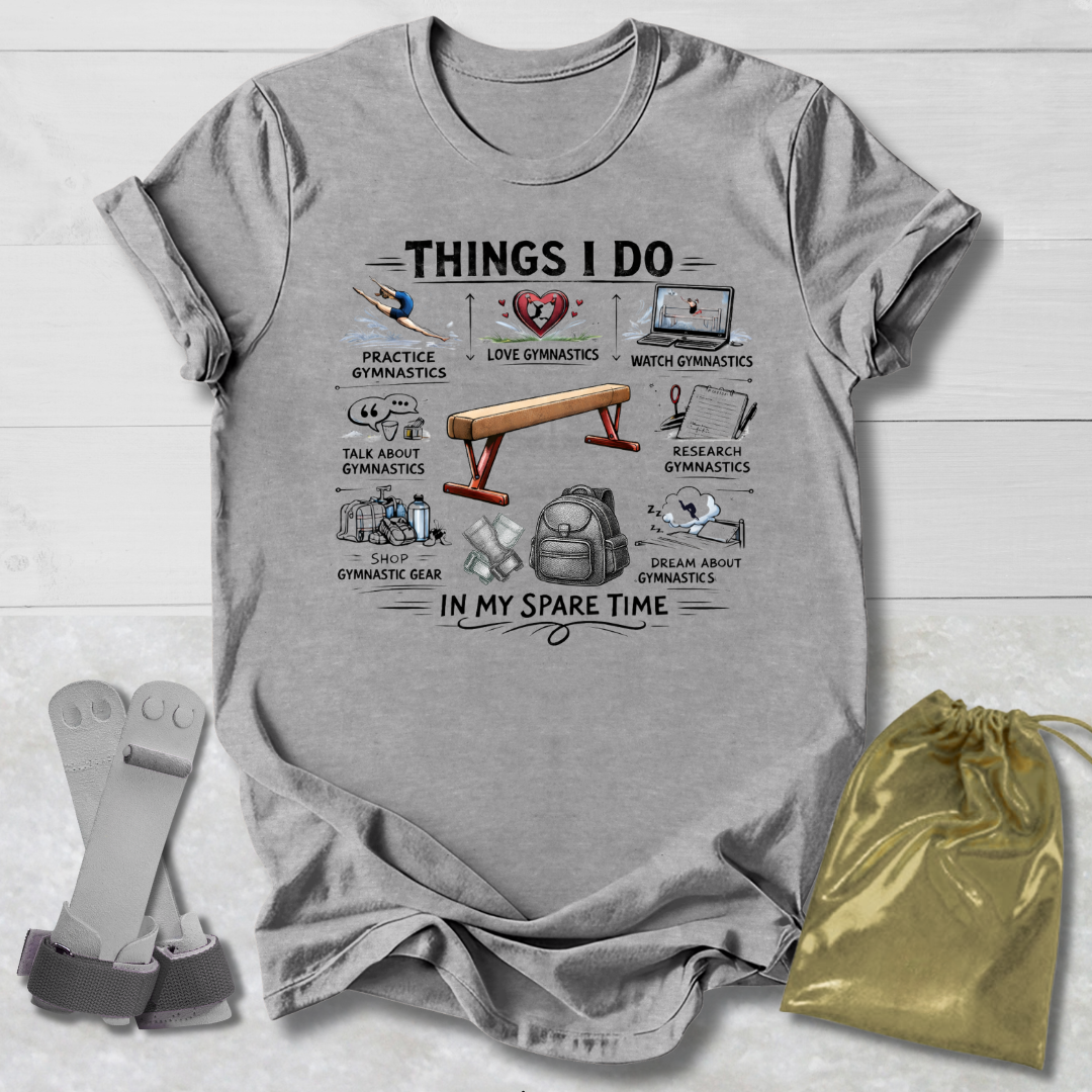 Gray t-shirt with a gymnastics things I do  graphic design and accessories on a wooden surface