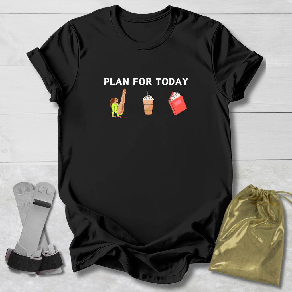 Black t-shirt with 'Gymnast Plan for Today' graphic on a wooden surface with socks and a drawstring bag.