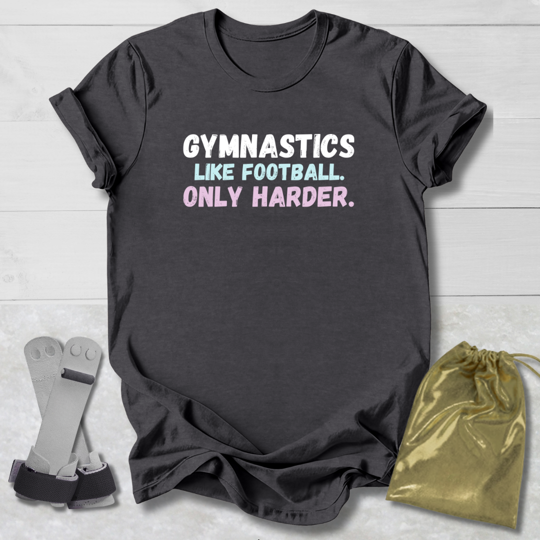 Dark gray t-shirt with humorous gymnastics quote, socks, and drawstring bag on a light wooden surface