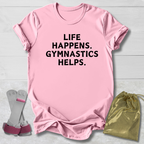 Pink t-shirt with 'Life happens. Gymnastics helps.' text, socks, and drawstring bag on a light gray background