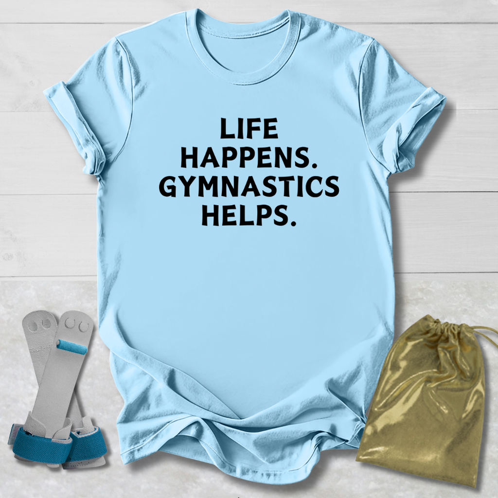 Light blue t-shirt with 'Life happens. Gymnastics helps.' text, socks, and drawstring bag on a light wooden surface.