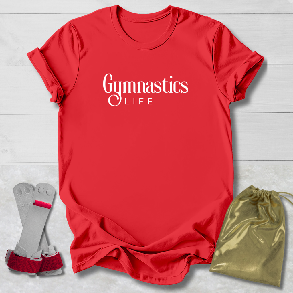 Red t-shirt with 'GYMNAST' text, gray socks with red accents, and a gold drawstring bag on a light wooden surface.