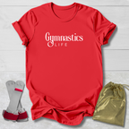 Red t-shirt with 'GYMNAST' text, gray socks with red accents, and a gold drawstring bag on a light wooden surface.