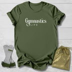 Green t-shirt with 'Gymnastics Life' text, socks, and drawstring bag on a light wooden surface.