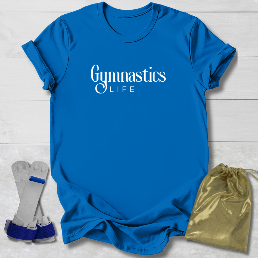 Blue t-shirt with 'Gymnastics Life' text, socks, and a gold drawstring bag on a light wooden surface.