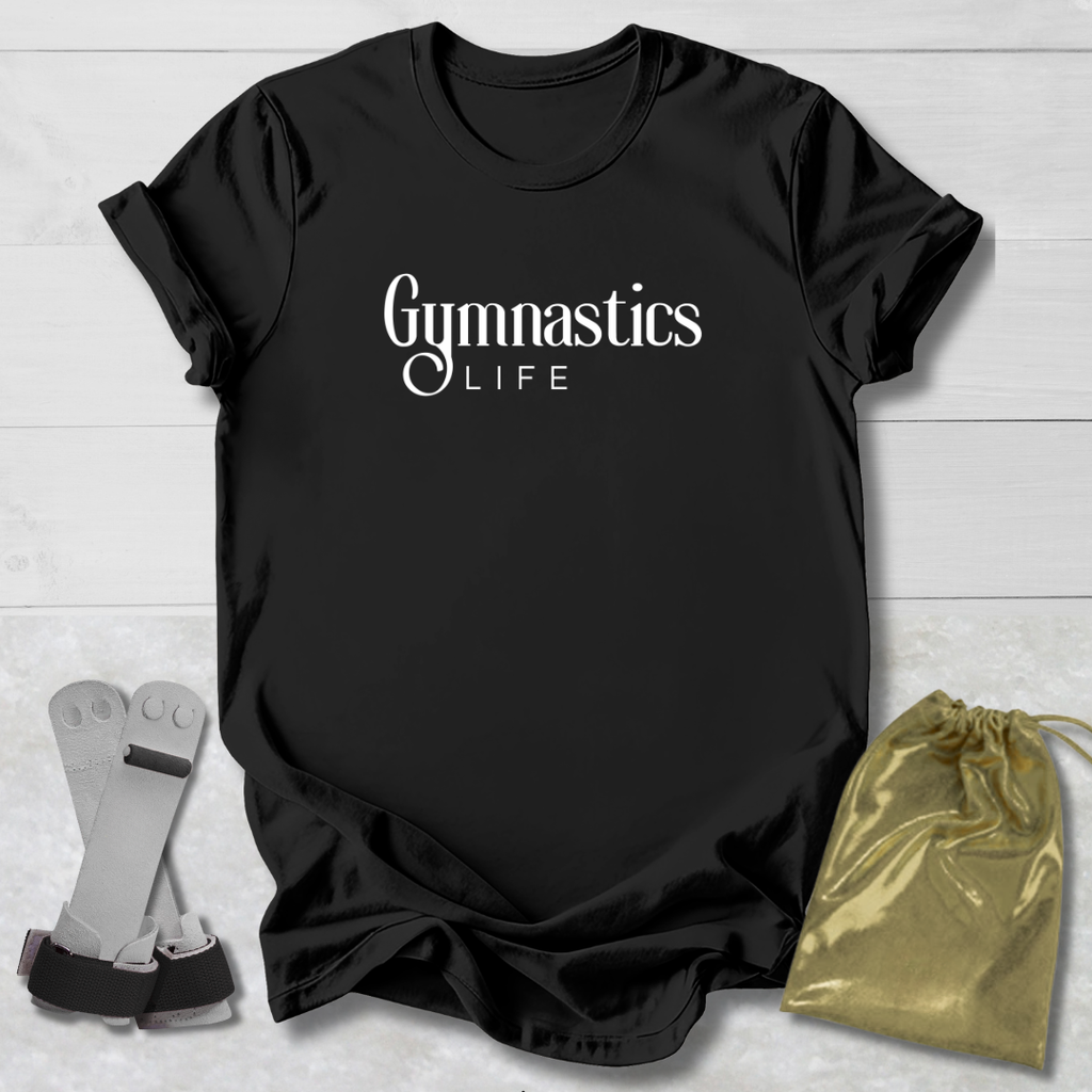 Black t-shirt with 'Gymnastics Life' text, socks, and drawstring bag on a light wooden surface