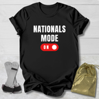 Black t-shirt with 'NATIONALS MODE ON' text and red toggle switch graphic on a light wooden surface.