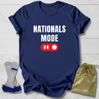 Navy blue t-shirt with 'NATIONALS MODE ON' text and graphics, socks, and drawstring bag on a light wooden surface.