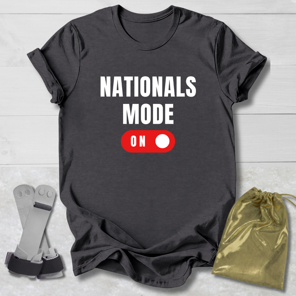 Dark gray t-shirt with 'NATIONALS MODE ON' text and a red switch graphic, displayed with socks and a drawstring bag on a light wooden surface.