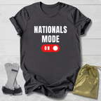 Dark gray t-shirt with 'NATIONALS MODE ON' text and a red switch graphic, displayed with socks and a drawstring bag on a light wooden surface.