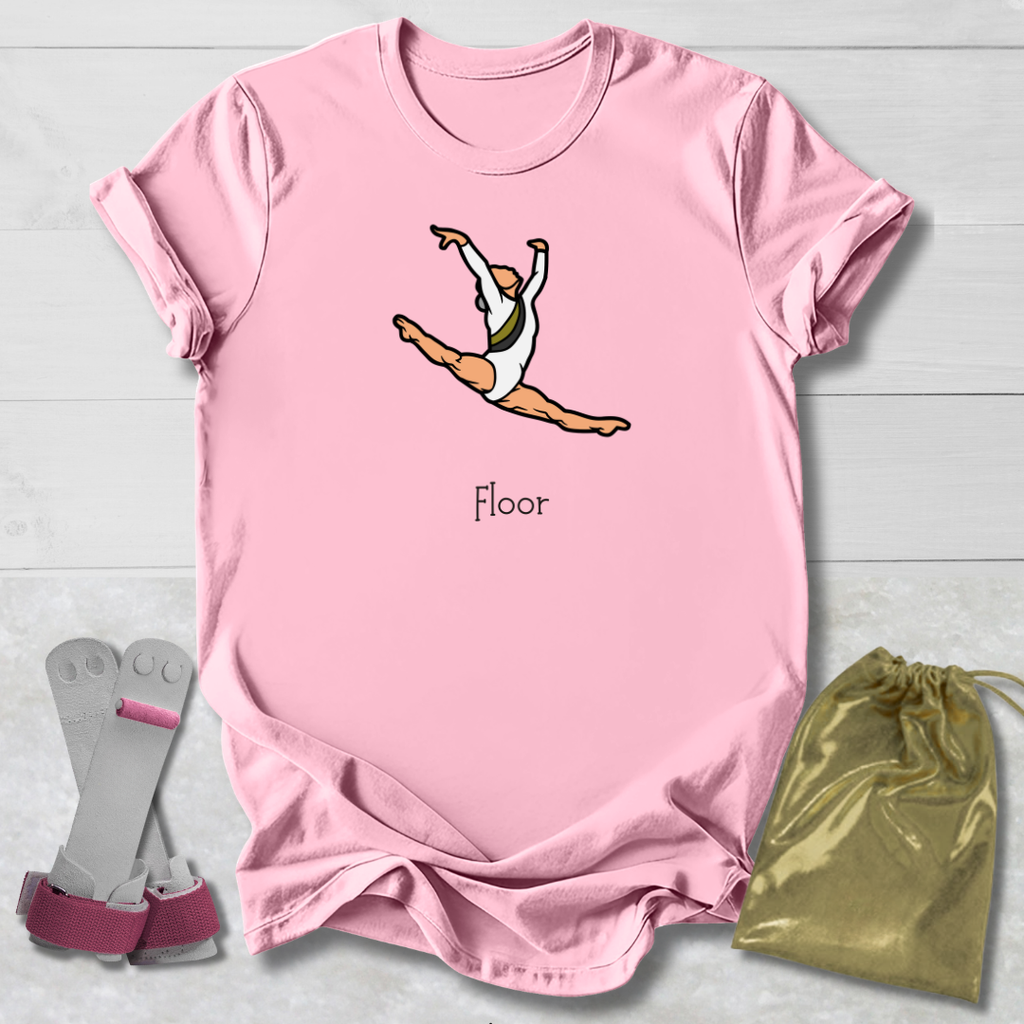 Pink t-shirt with a graphic of a gymnast and the word 'Floor', accompanied by gray socks and a gold drawstring bag on a light wooden surface.