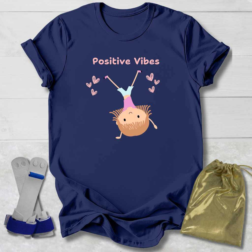 Navy blue t-shirt with 'Positive Vibes' graphic on a light wooden surface with socks and a drawstring bag.