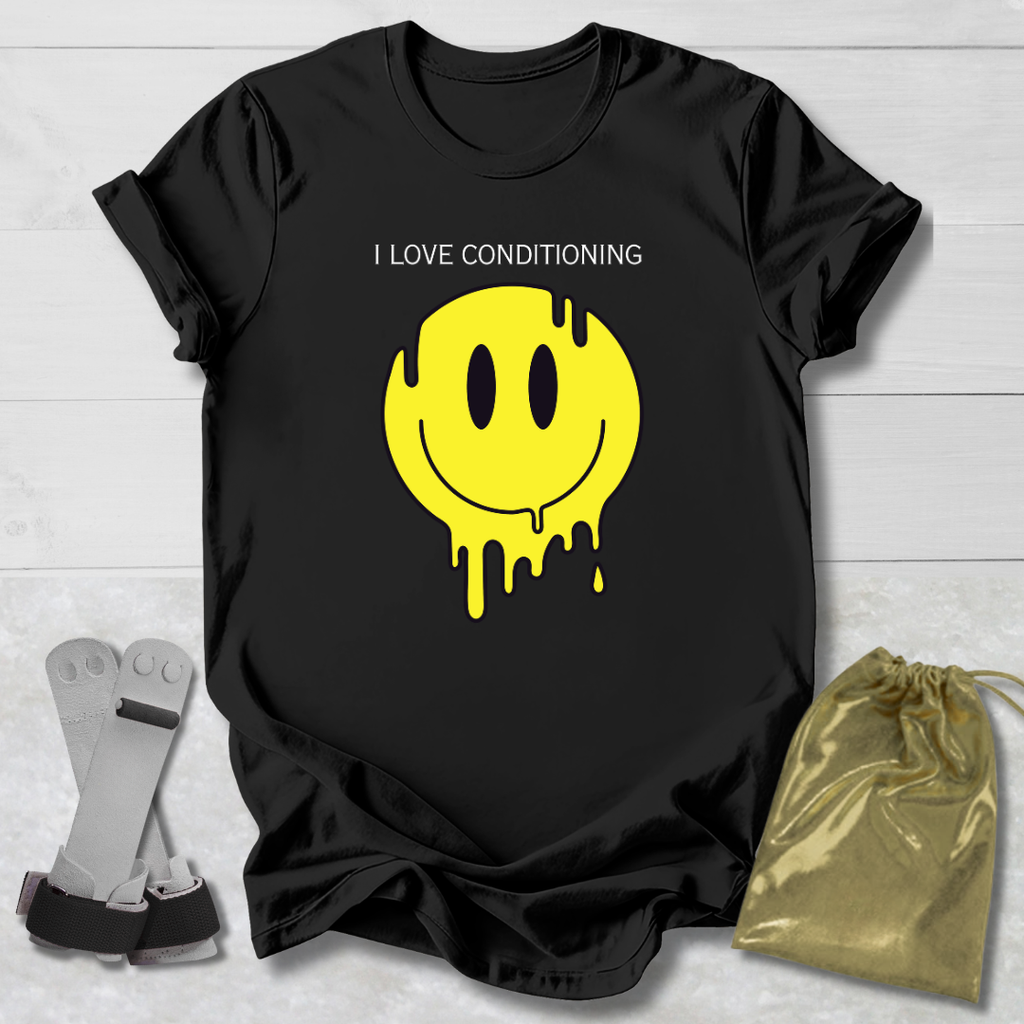 Black t-shirt with yellow smiley face graphic and text 'I Love Conditioning' on a light wooden surface.