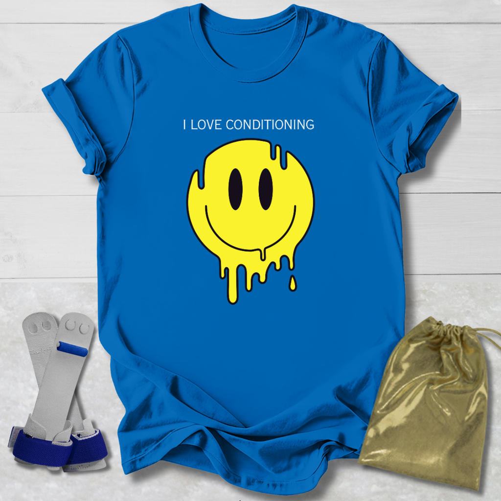 Blue t-shirt with yellow smiley face graphic and text, socks, and drawstring bag on a light wooden surface.