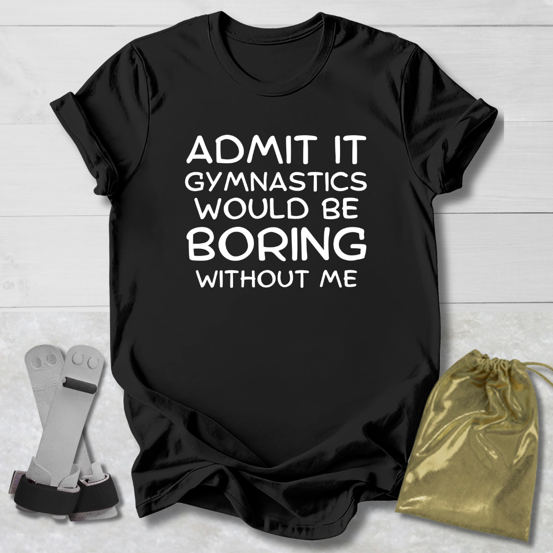 Black t-shirt with text 'Admit it, gymnastics would be boring without me' on a light wooden surface.