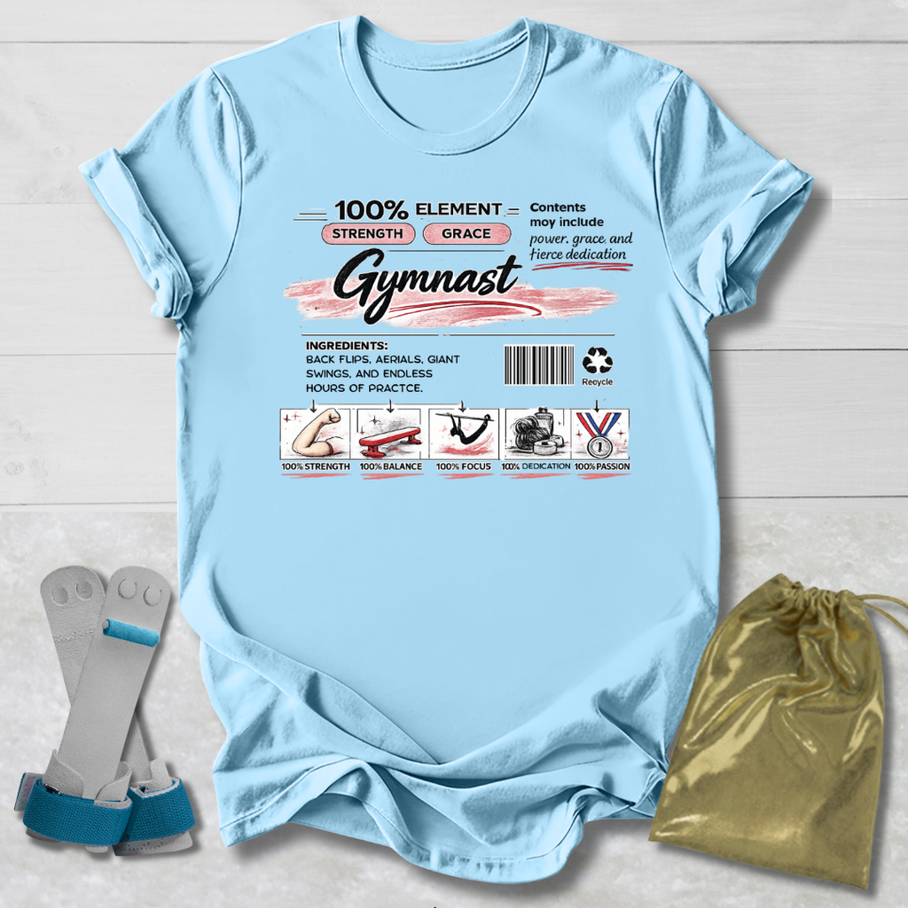 Light blue t-shirt with gymnast-themed graphics and text on a wooden surface.
