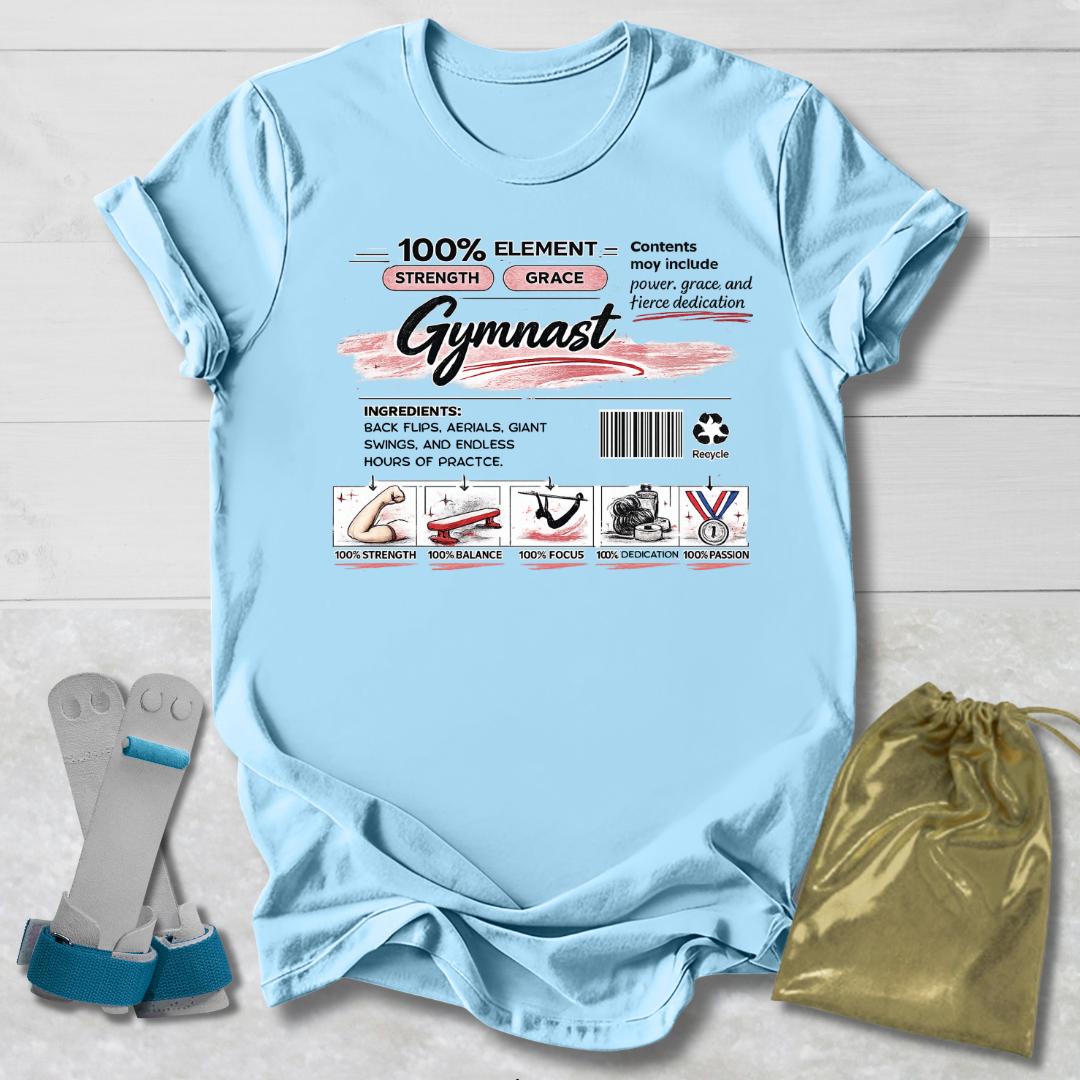 Light blue t-shirt with gymnast-themed graphics and text on a wooden surface.