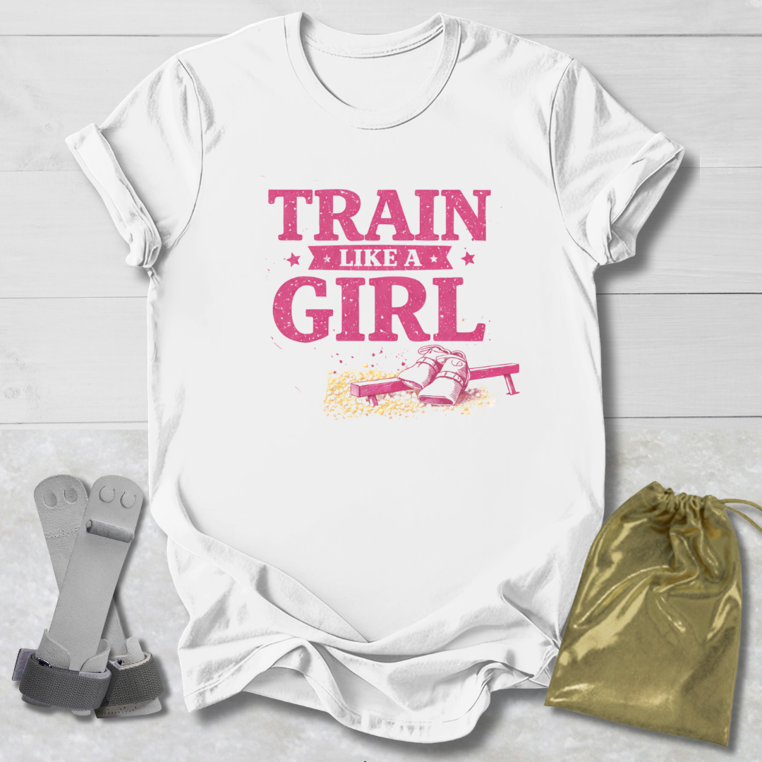 White t-shirt with 'Train Like a Girl' text and graphics on a light wooden surface.