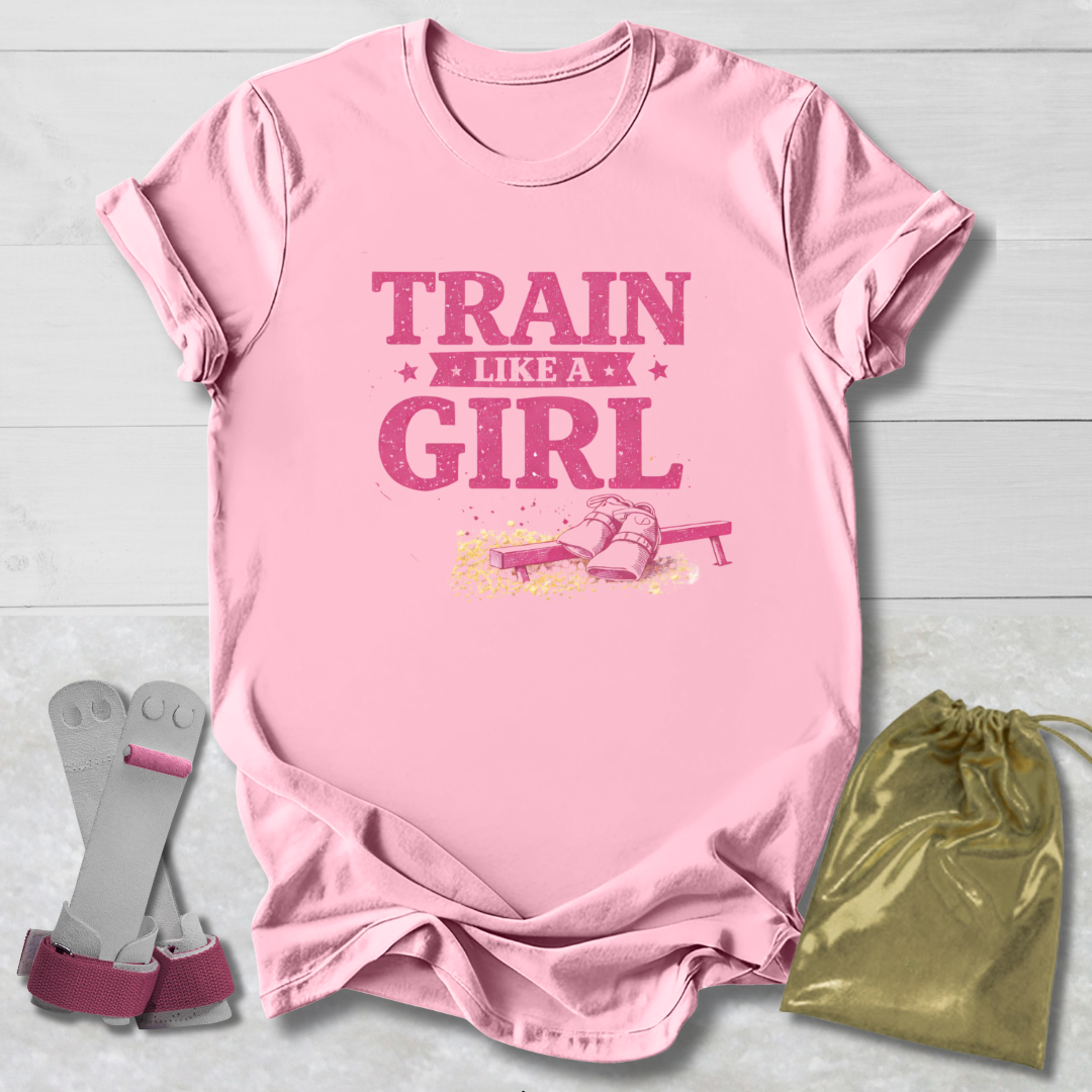 Pink t-shirt with 'Train Like a Girl' text, socks, and drawstring bag on a light wooden surface