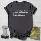 Black t-shirt with humorous text on a light wooden surface with socks and a drawstring bag.