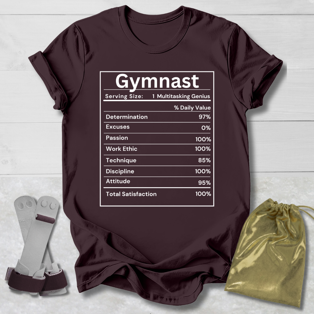 Maroon t-shirt with 'Gymnast' graphic on a wooden surface with socks and a drawstring bag.