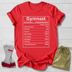 Red t-shirt with 'Gymnast' graphic, socks, and drawstring bag on a light wooden surface