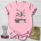Pink t-shirt with cartoon design, socks, and drawstring bag on a light wooden surface