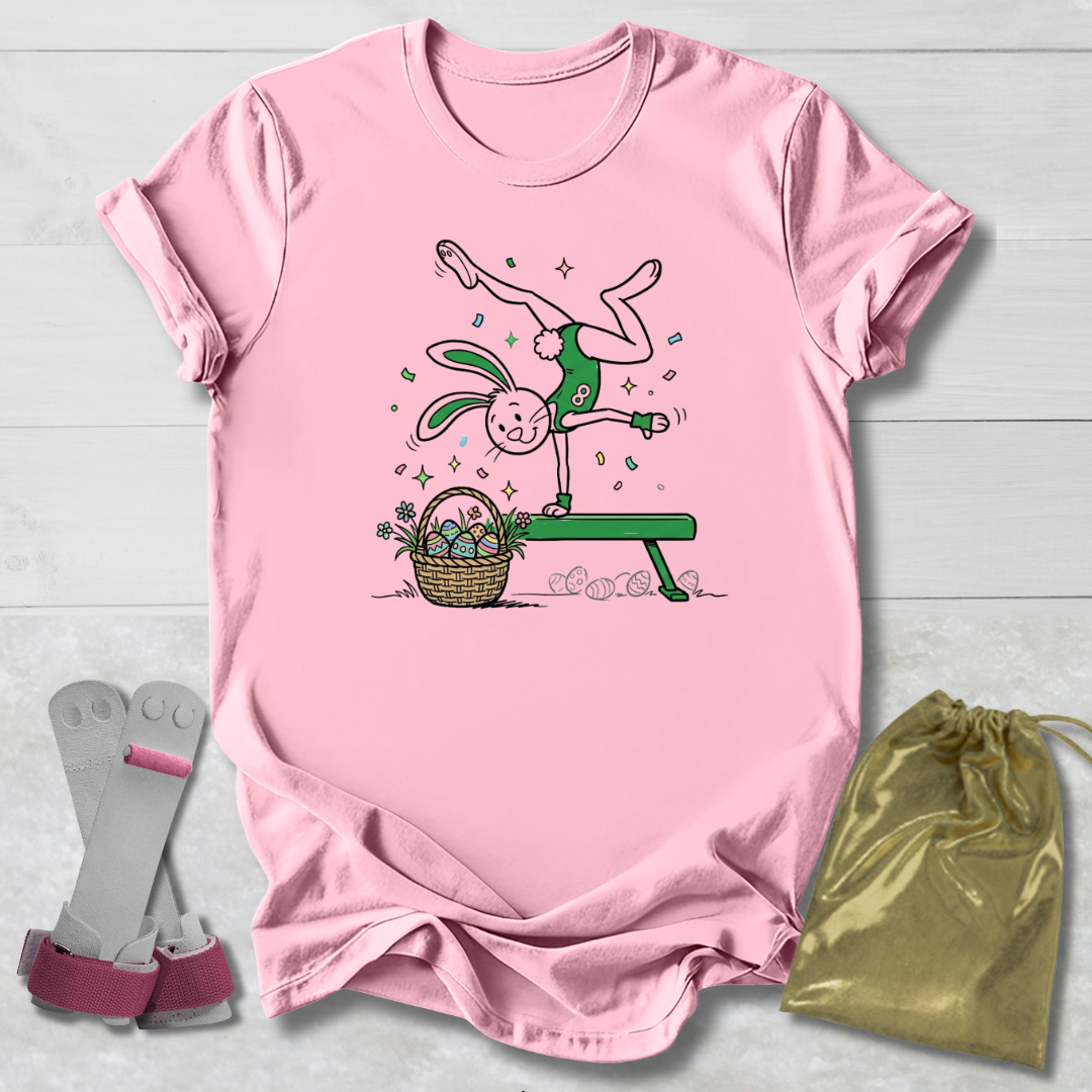 Pink t-shirt with cartoon design, socks, and drawstring bag on a light wooden surface