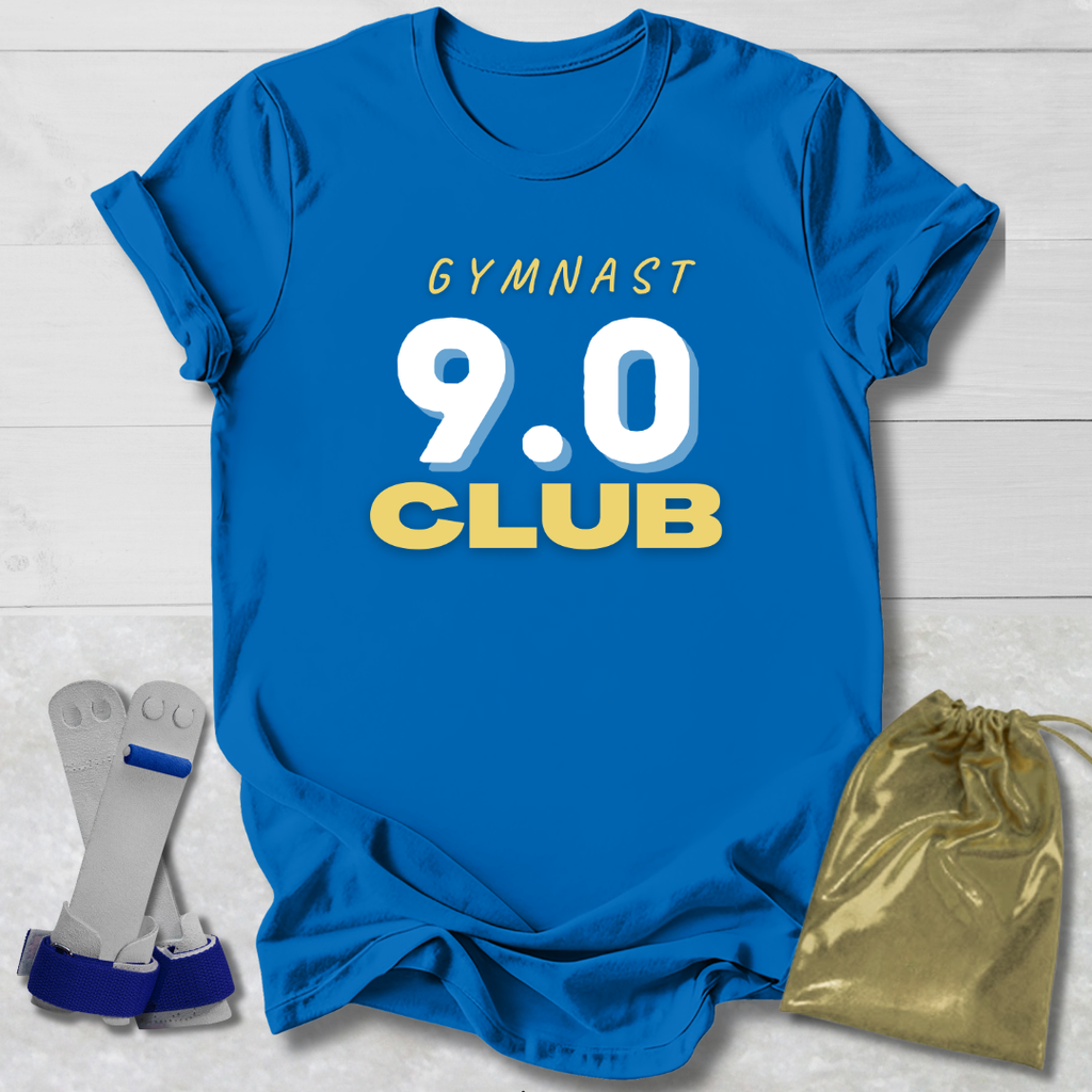 Blue t-shirt with 'GYMNAST 9.0 CLUB' text, socks, and drawstring bag on a light wooden surface