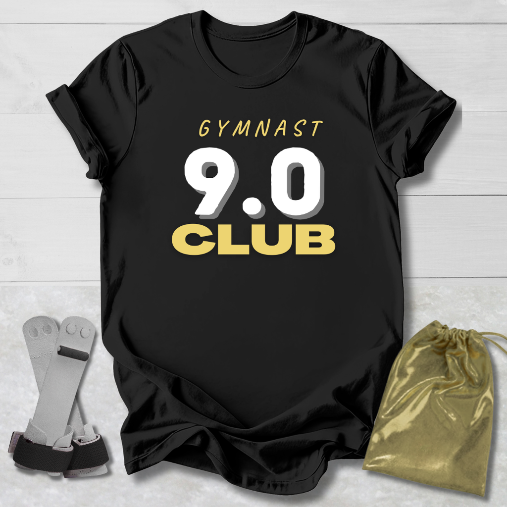 Black t-shirt with 'Gymnast 9.0 Club' text, socks, and drawstring bag on a light wooden surface