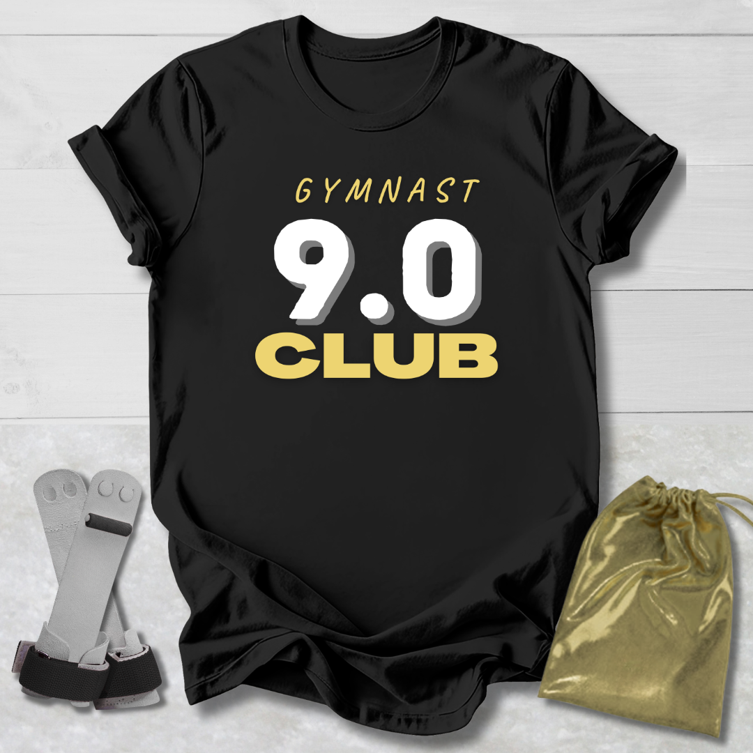 Black t-shirt with 'Gymnast 9.0 Club' text, socks, and drawstring bag on a light wooden surface