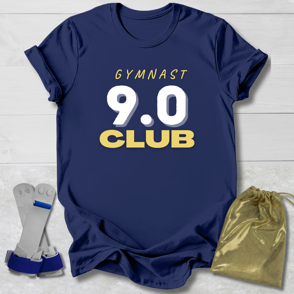 Navy blue t-shirt with 'Gymnast 9.0 Club' text, socks, and drawstring bag on a light wooden surface.